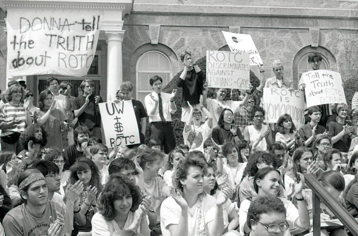 Students outside of Bascom Hall circa 1990 hold signs protesting discrimination in the ROTC.