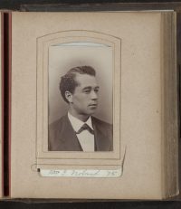 William Noland is seated for a portrait. Wearing a suit and tie, he is pictured looking off and to the left.