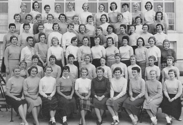 A yearbook page with several women singing and dancing in for a black and white photo.