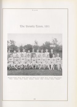 Ike Bernstein and track team athletes seated for a large group photo with trees in the background.