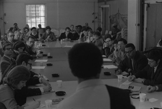 A group of people seated around a conference table at the "The Black Revolution: To What Ends?" conference.