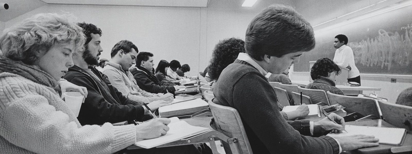 Professor Nellie McKay stands at the front of a classroom lecturing students circa 1985.