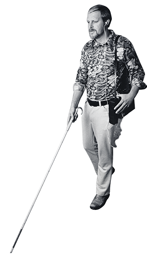 A blind man uses a cassette audio tape recorder map and a white cane.